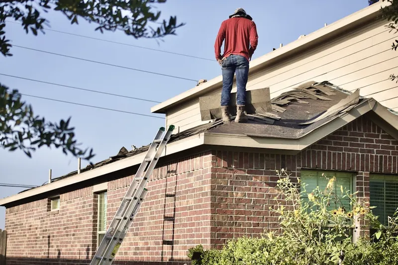 Professional roofer working on a residential roof in Dorr